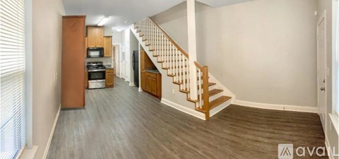 A spacious hallway with a staircase leading to the second floor.