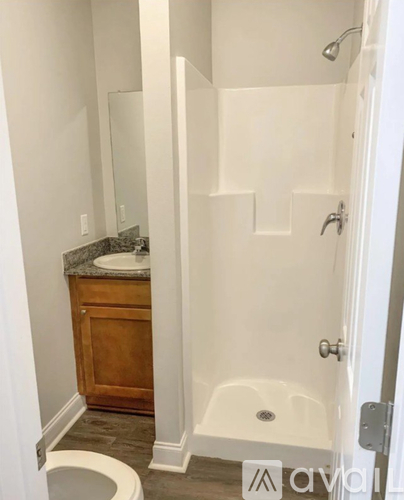 A white bathroom with a toilet, sink, and bathtub.