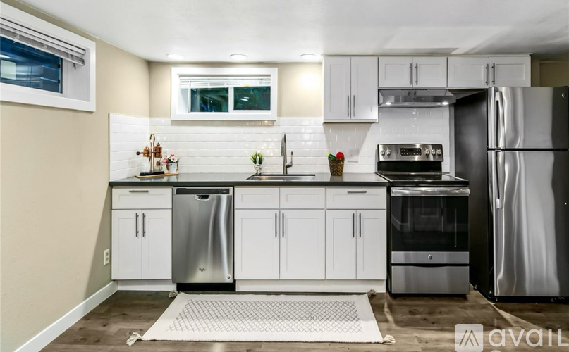 A kitchen with white cabinets and stainless steel appliances.