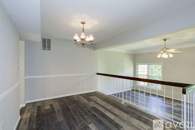 A room with a wooden floor and a chandelier.