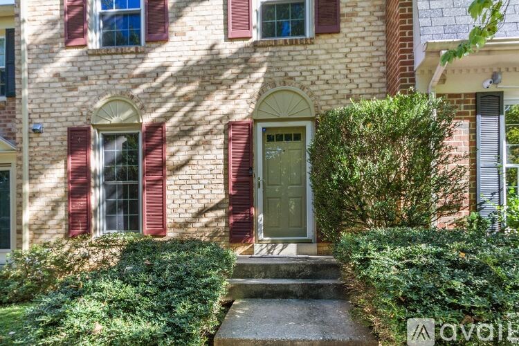 A house with a green door and red shutters.