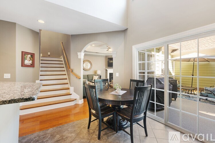 A dining room with a table set for four.