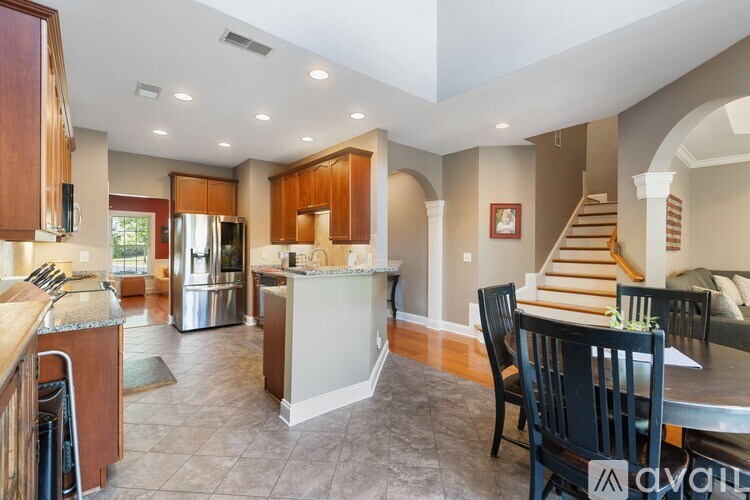 A spacious kitchen with a dining table set up.