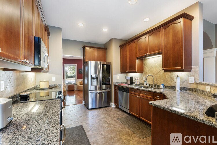 A kitchen with wooden cabinets and granite countertops.