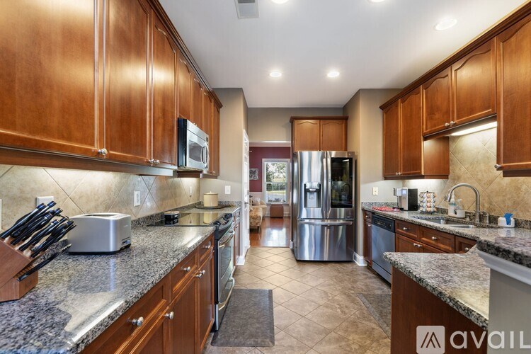 A kitchen with wooden cabinets and granite countertops.