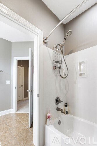 A bathroom with a tub and a shower.