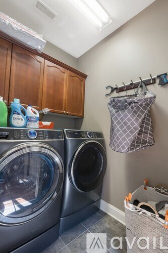Two front loading washing machines in a laundry room.