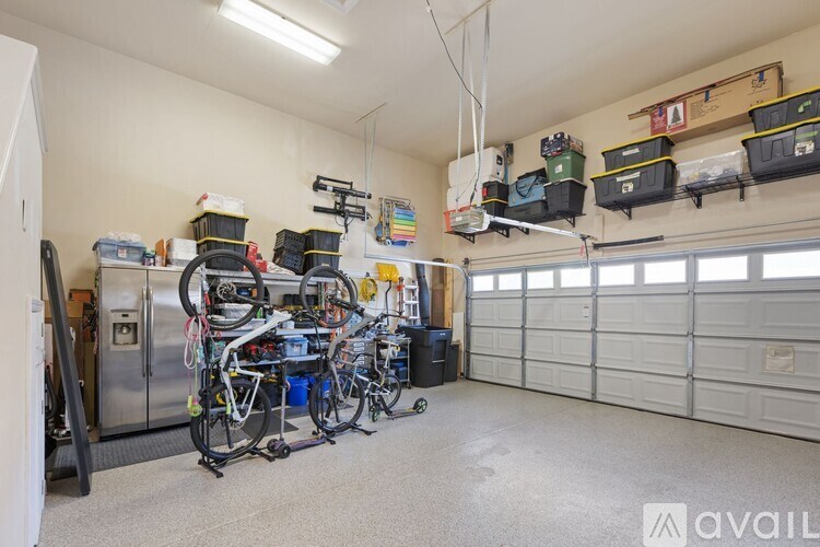 A room with a bicycle repair station and storage bins.