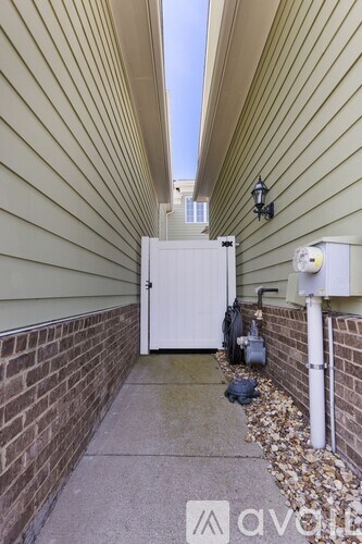 A white door is on the side of a house.