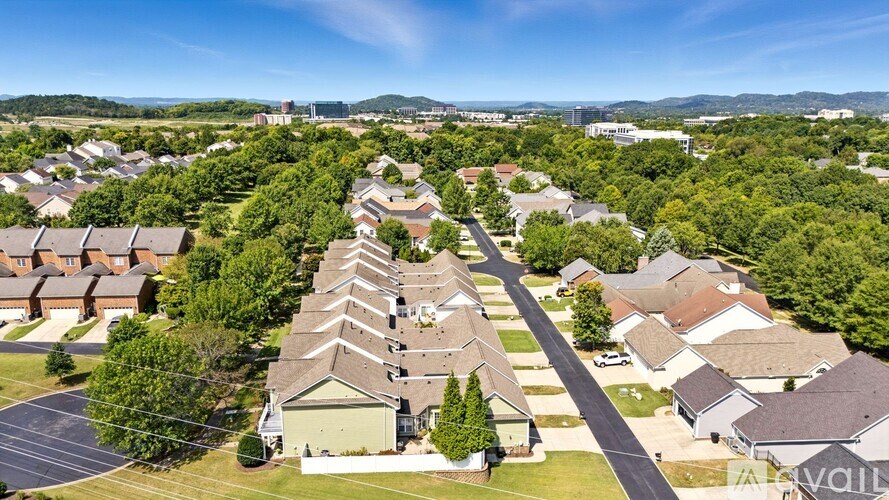 A bird's eye view of a residential neighborhood with houses and trees.