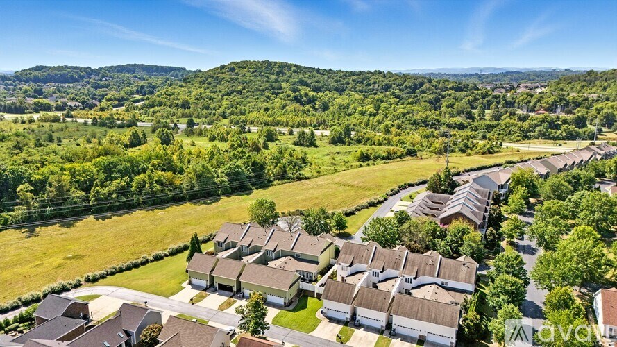 A bird's eye view of a residential area with houses and greenery.
