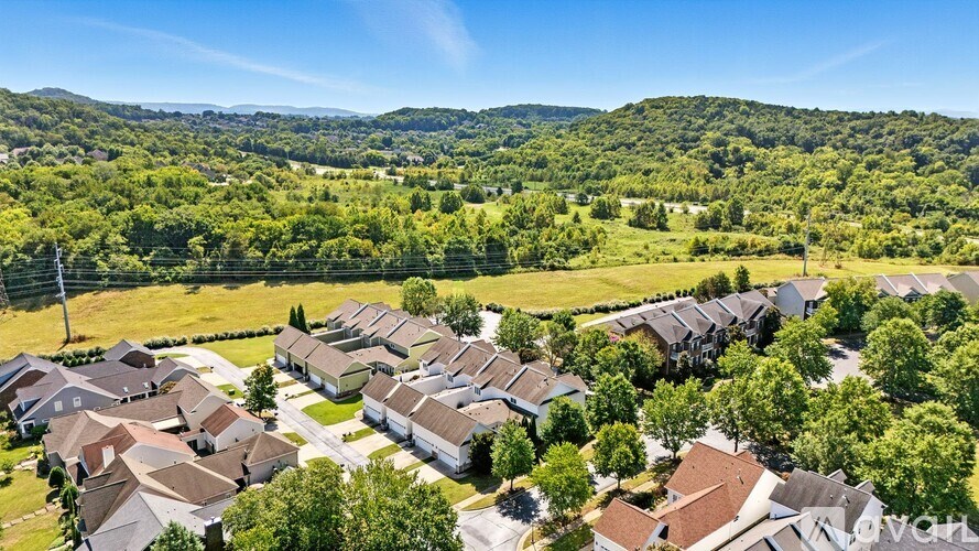 A bird's eye view of a residential area with houses and greenery.