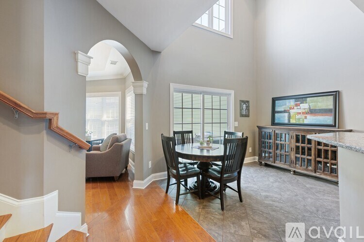 A dining room with a table set for four.