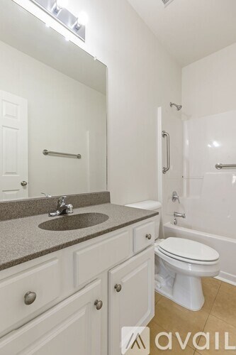 A bathroom with a sink, toilet, and bathtub.