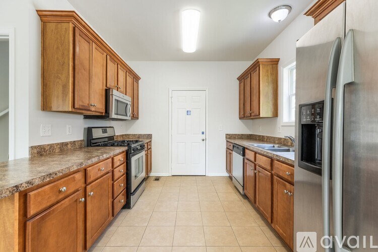 A kitchen with wooden cabinets and stainless steel appliances.