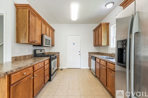 A kitchen with wooden cabinets and stainless steel appliances.