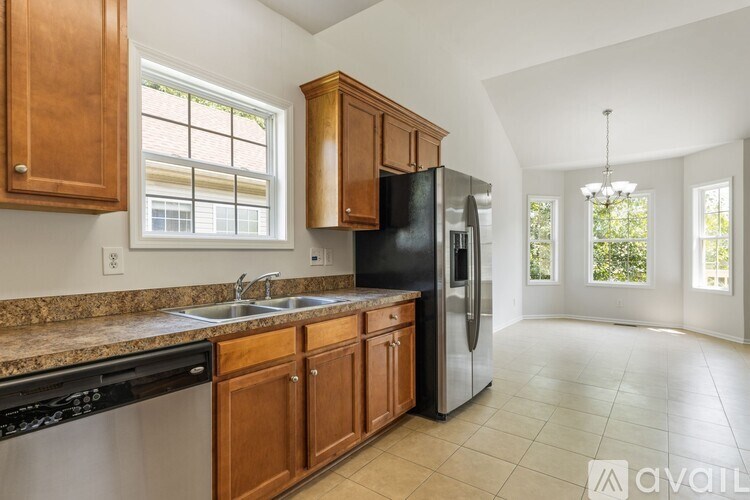 A kitchen with wooden cabinets and black appliances.
