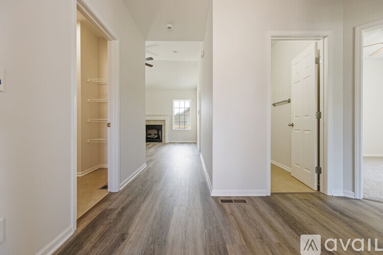 A long hallway with a light at the end.