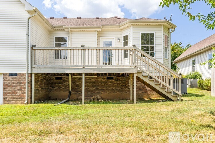 A house with a balcony and stairs leading to the second floor.