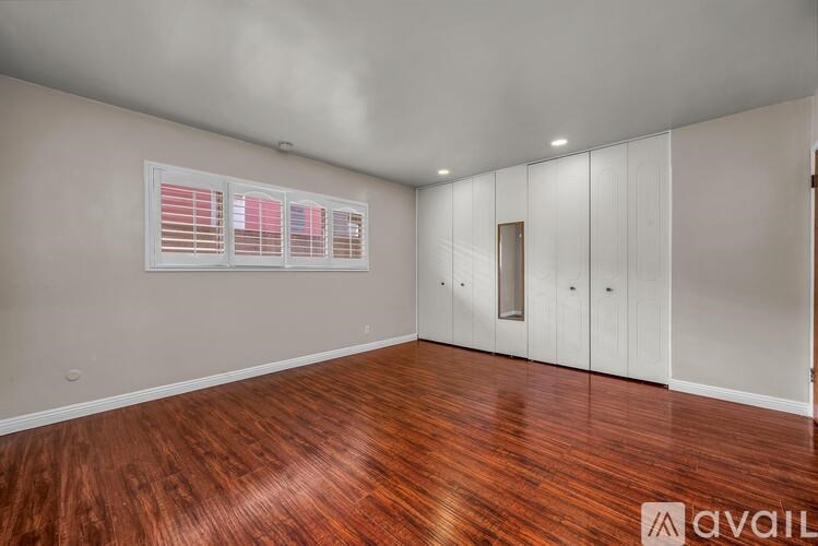 A room with wooden floors and white walls.