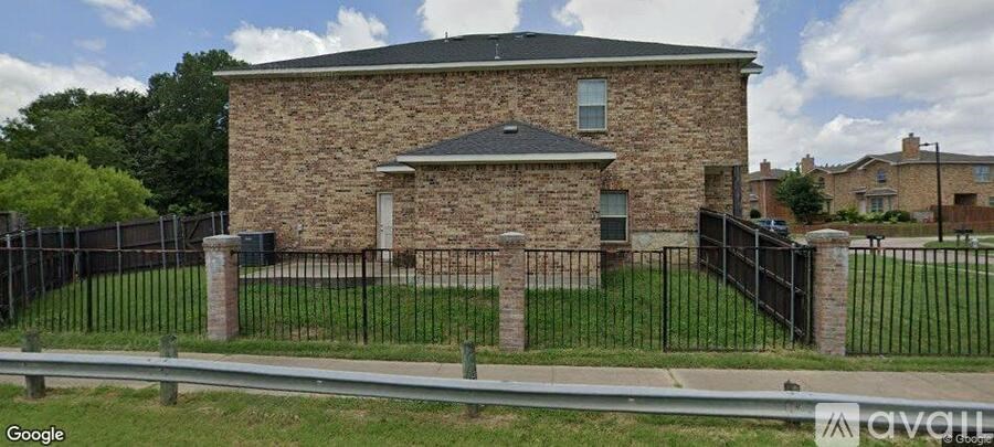 A house with a black fence in front of it.