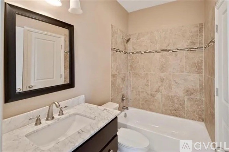 A bathroom with a marble countertop and a white toilet.