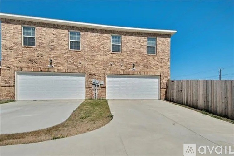 A house with a garage and a driveway in front.