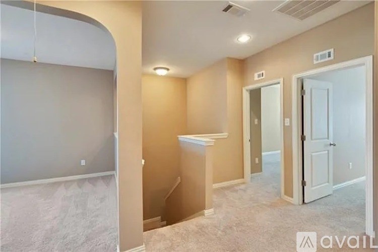 A room with a carpeted floor and a white door.