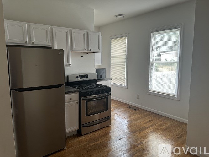 A kitchen with a refrigerator, stove, and oven.