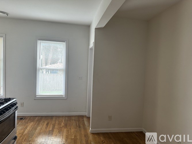 A room with a window and a stove is available for rent.