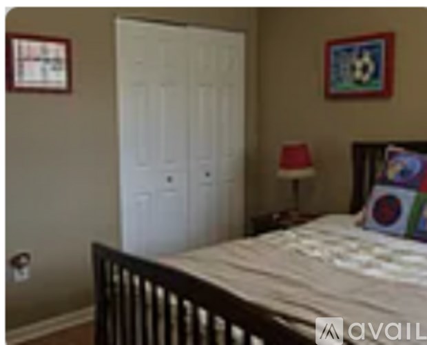 A bedroom with a white door and a bed.