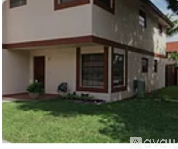 A house with a brown door and a window.