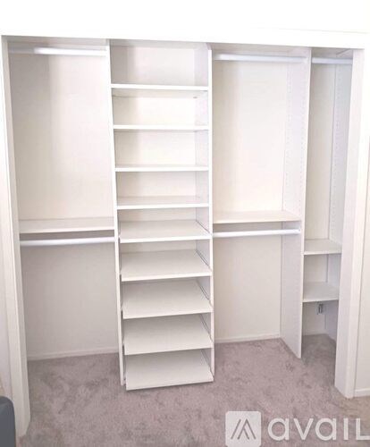 A white shelving unit with multiple shelves is available for rent.