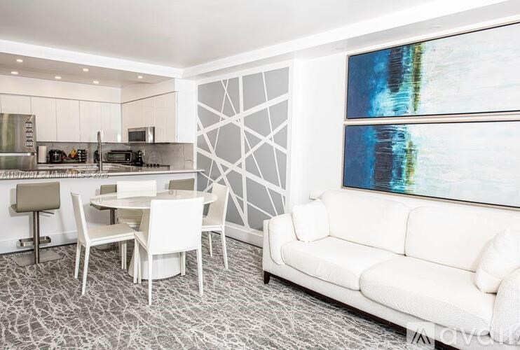 A modern living room with a dining table and chairs.
