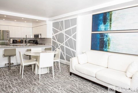 A modern living room with a dining table and chairs.