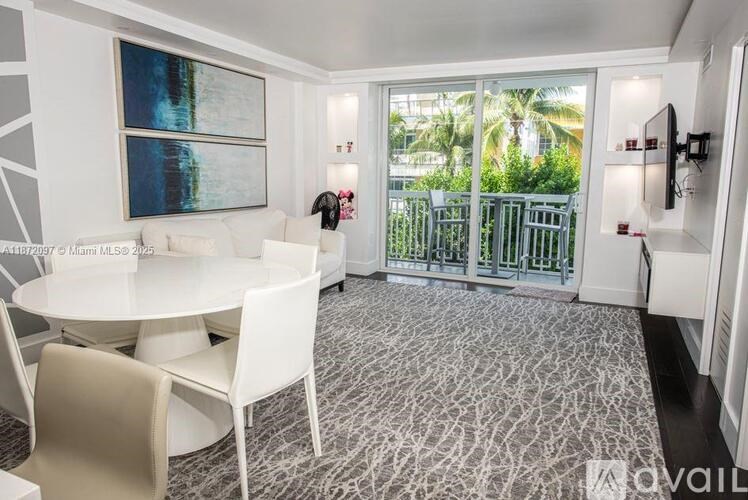 A dining room with a table and chairs and a painting on the wall.