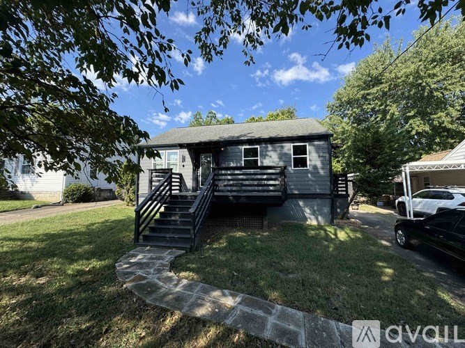 A house with a carport and a car parked in front.