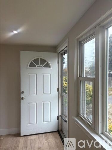 A white door with a window to the right.