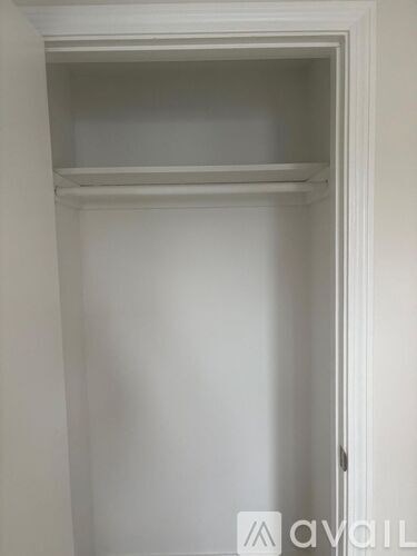 A white door with a shelf above it.