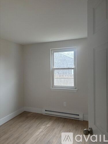 A room with a window and a door.