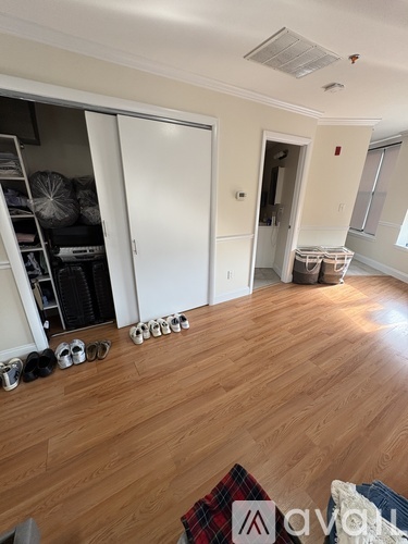 A room with wooden floors and a white door.