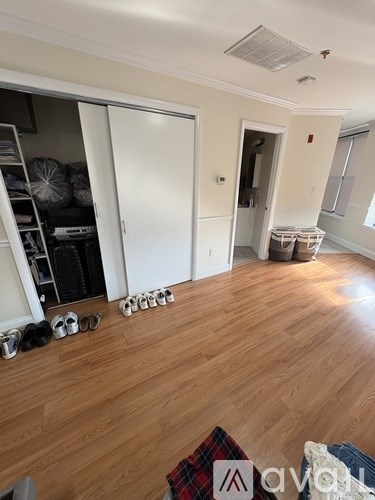 A room with wooden floors and a white door.