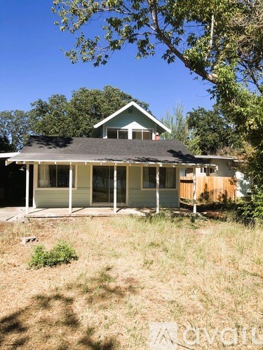 A house with a brown door and a white porch.