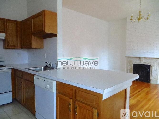 A kitchen with wooden cabinets and a white countertop.