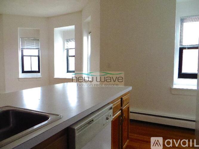 A kitchen with a sink and a window.
