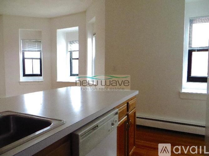 A kitchen with a sink and a window.