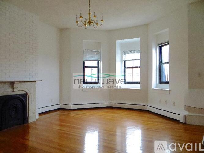 A living room with a fireplace and a chandelier.