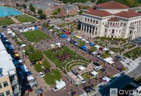 An aerial view of a large building with a pool in front of it.
