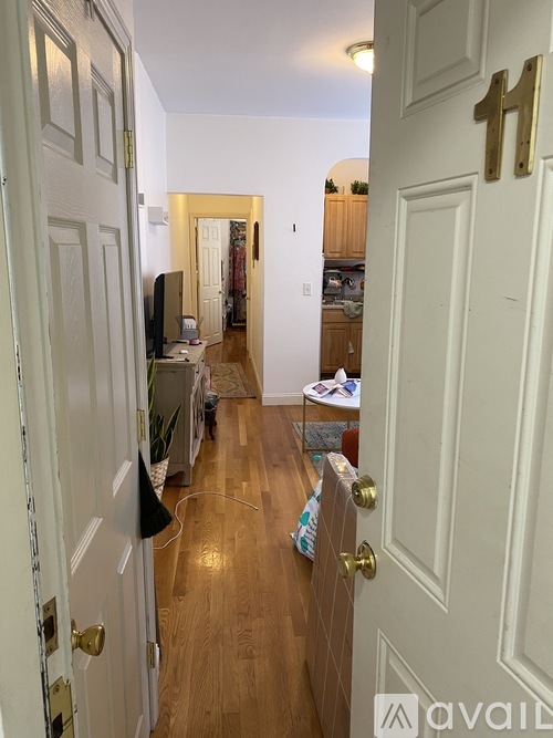 A hallway with a door on the right and a door on the left.