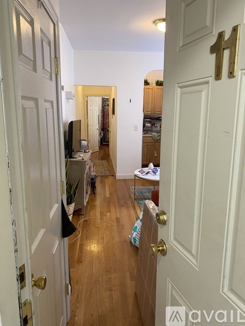A hallway with a door on the right and a door on the left.